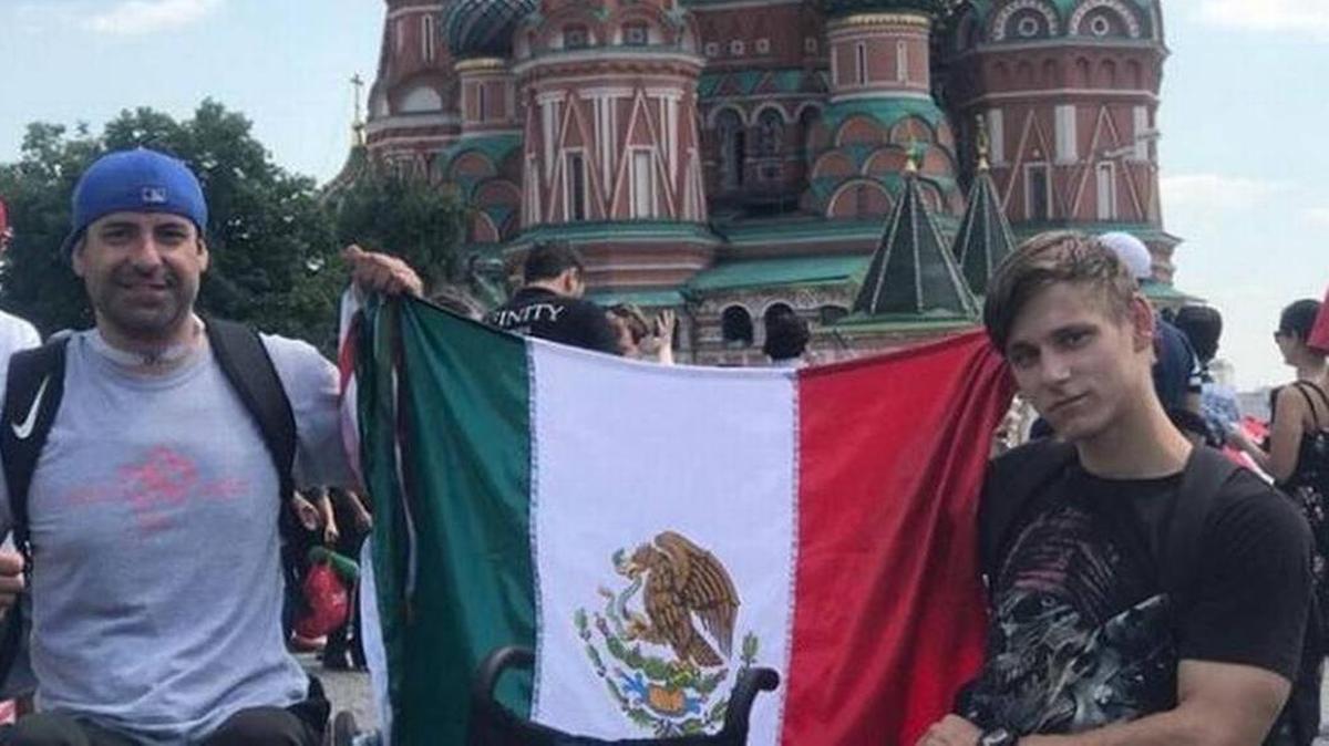 Abel Vera, left, and a Russian man, right, hold up the Mexican flag. Vega traveled to Russia during the FIFA World Cup 2018 and gave the Russian man a wheelchair as a gift.