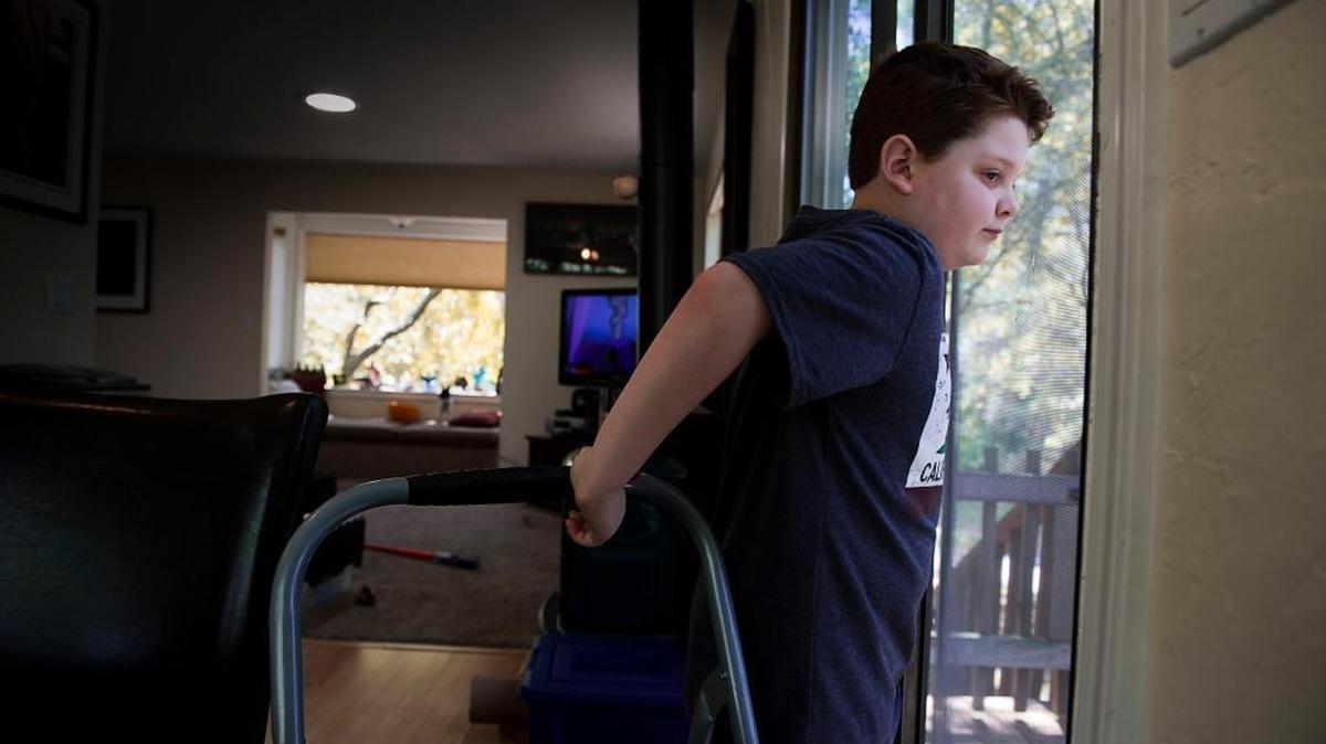 Silas Hurd gazes at the view outside his family’s Penn Valley home. He has experienced some relief from the seizures that have wracked his body since age 3, and has returned to a school setting a couple days a week. His parents attribute the improvement to experimental cannabis formulas.