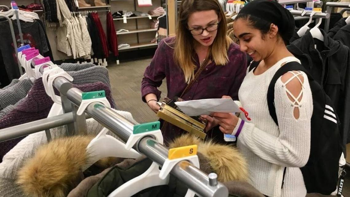 Gracyn Torigian, left, and Haroon Sekhon, both 17, shop for Christmas presents to teens in foster care.
