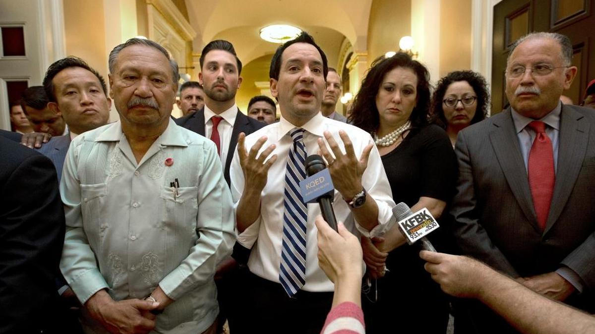 Assembly Speaker Anthony Rendon, D-Paramount, center, speaks to farmworkers and their supporters in the Capitol last week after postponement of a vote on farmworker overtime until Monday.