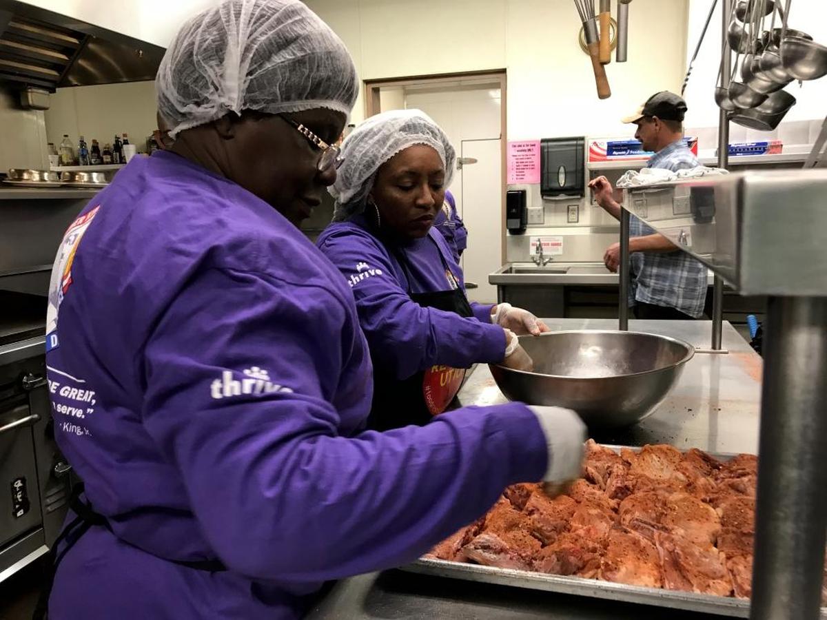 Critical Care Nurse Helena Opoku and Patient Care Technician Sereda Crippen prepare food to serve the residents of the Poverello House during Kaiser Permanente Fresno’s annual MLK Day Of Service.