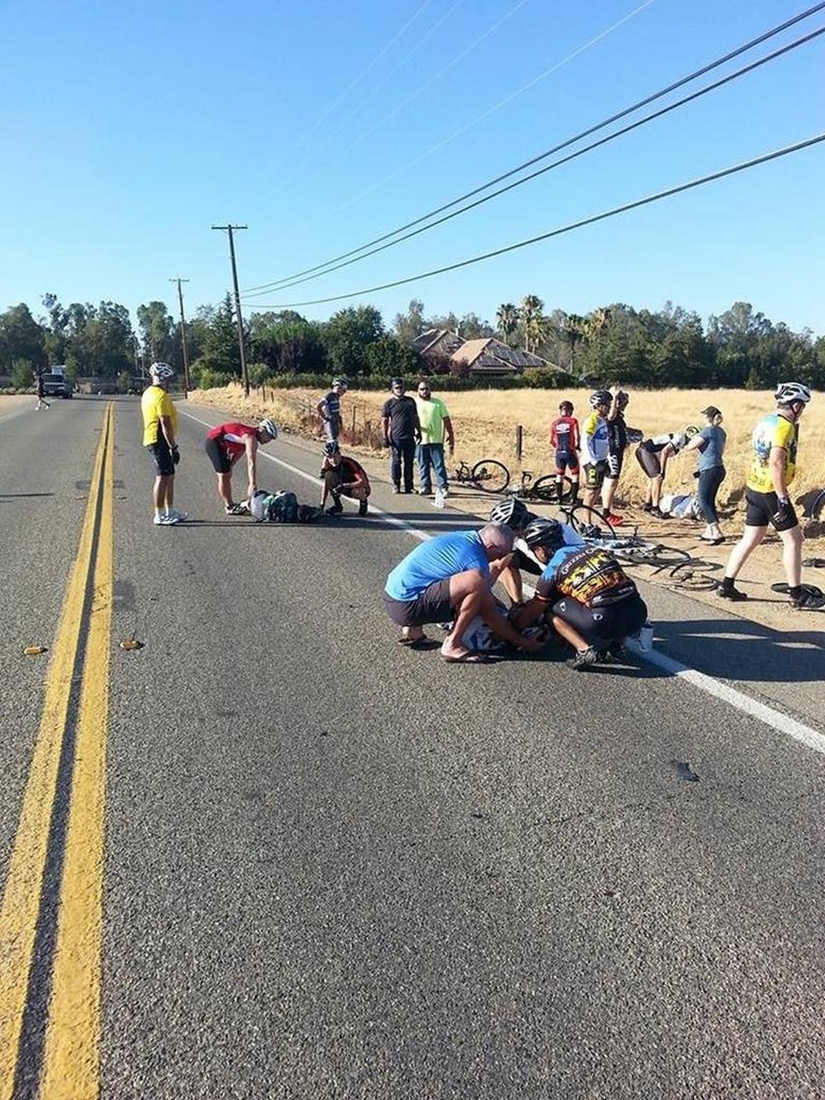 Cyclists tend to colleagues hurt when an intoxicated man drove his motorcycle into the group as it rode along Auberry Road on July 25, 2017.