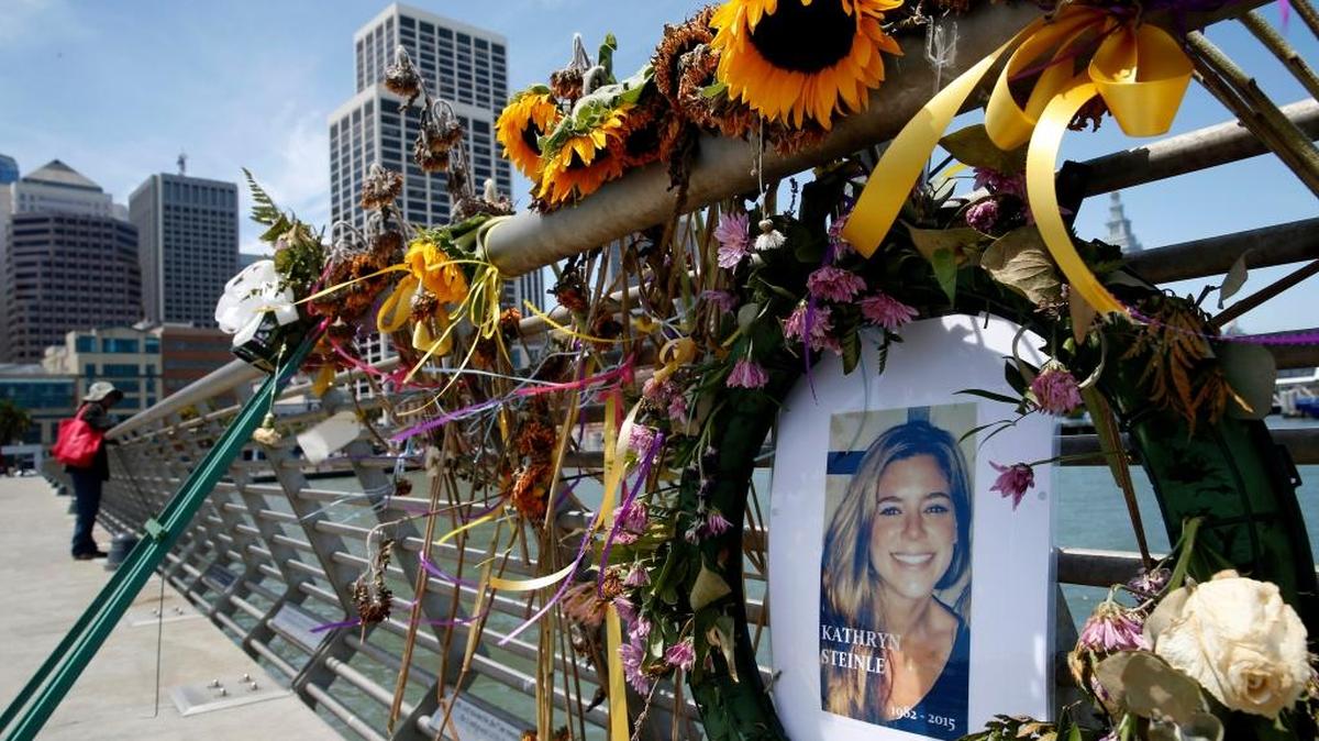 In this July 17, 2015 photo, flowers and a portrait of Kate Steinle remains at a memorial site on Pier 14 in San Francisco.