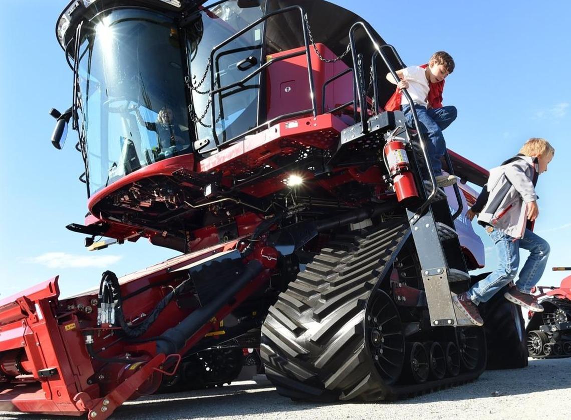 7-year-old cousins Kaeden Barrios, atop ladder, and Paxton Chavez, right, explore one of the massive Case combines at the World Ag Expo on Feb. 13 as Paxton’s 4-year-old brother Bronxton Chavez explores the cab. For these farm kids from King City, they said this was like their Disneyland.