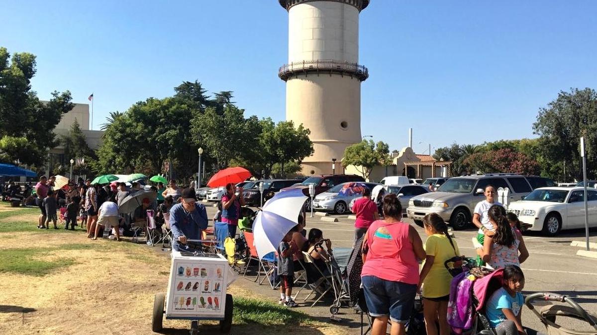 Kids and parents wait in line before the start of the annual United Way of Fresno and Madera counties Backpack Giveaway at Eaton Plaza in Downtown Fresno. In 2016, 2,000 backpacks filled with school supplies and age appropriate books were distributed to students age five to 15.