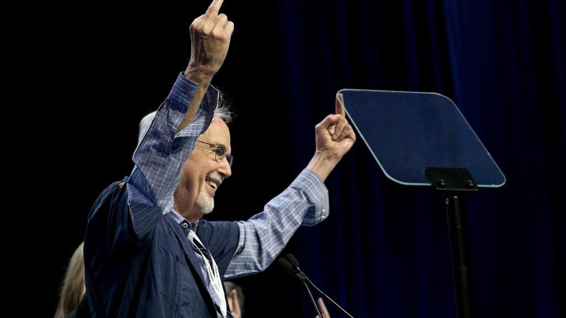 John Burton, outgoing chairman of the California Democratic Party, gives a double middle-finger salute to President Donald Trump during the state convention in Sacramento on Saturday, May 20, 2017.