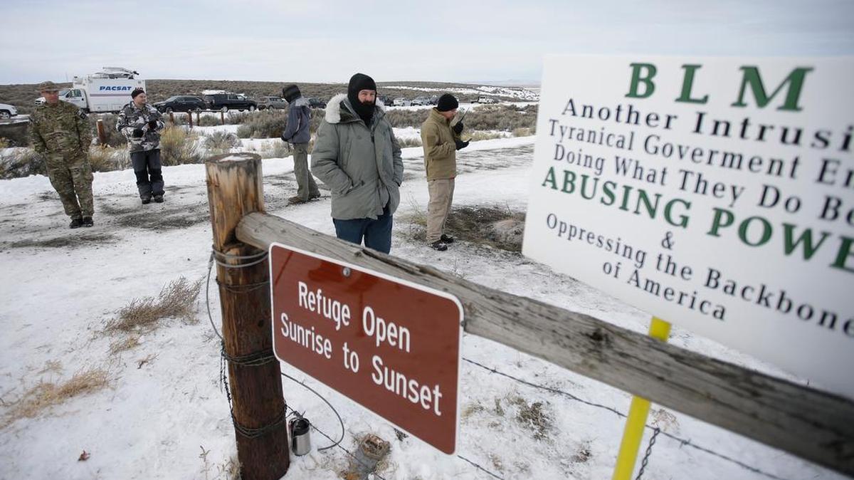 Members of the group occupying the Malheur National Wildlife Refuge stand guard on Monday. The group calls itself Citizens for Constitutional Freedom and has sent a "demand for redress" to local, state and federal officials.