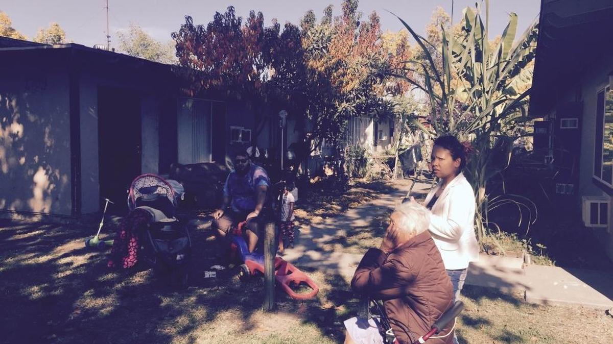 Rigoberto De Lamora, Tauv Soy and Noi Khounesy sit outside their apartments Tuesday morning, Nov. 24, 2015. They live in the central Fresno complex that’s been without hot water and heat for about two weeks because of broken gas lines.