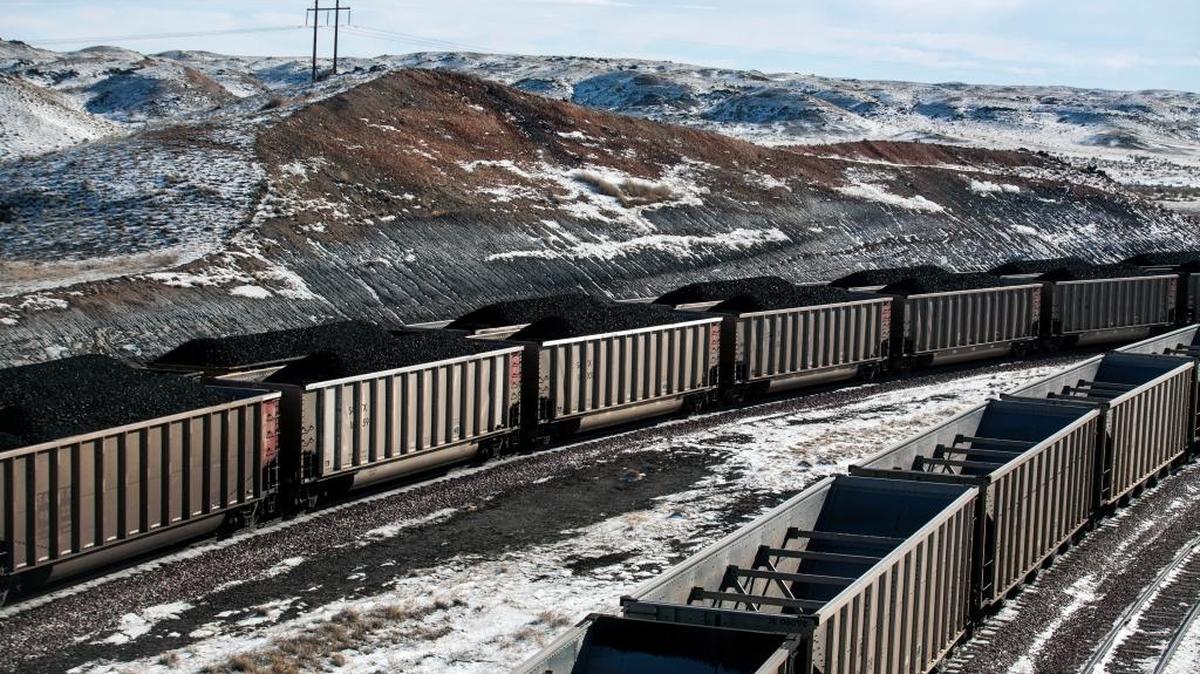 Rail cars are filled with coal at a mine north of Douglas, Wyo. The U.S. Supreme Court on Tuesday delayed new regulations to curb emissions from coal-fired electricity.