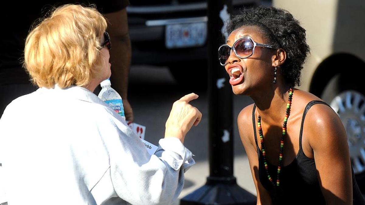 
Lynn Acton, left, and Taj Sconyers exchange words on Aug. 12 during dual demonstrations, as supporters of former Ferguson police Officer Darren Wilson rallied across the street from a Black Lives Matter protest in Columbia, Mo.
