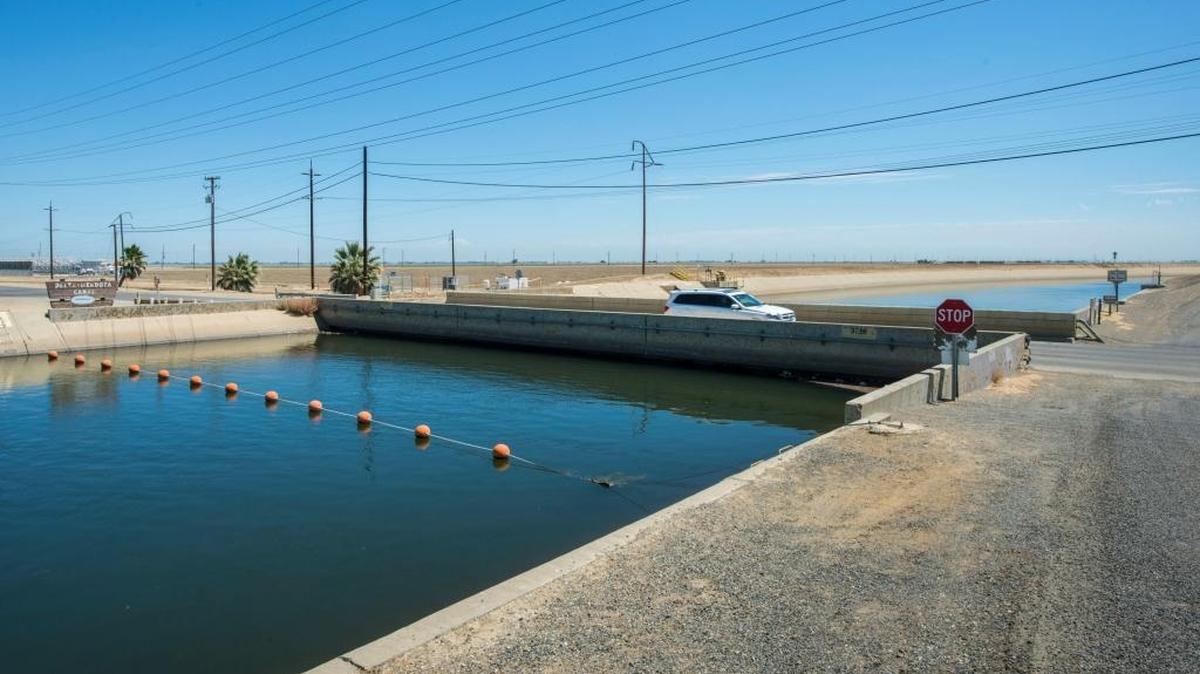 This July 23, 2015, photo provided by the California Department of Water Resources shows the Russell Avenue bridge over the Delta-Mendota Canal in Firebaugh. The drought has caused the bridge to subside until there is almost no space between bottom of bridge decking and canal water surface. NASA says parts of the San Joaquin Valley are sinking faster than ever as groundwater is being pumped during the drought.