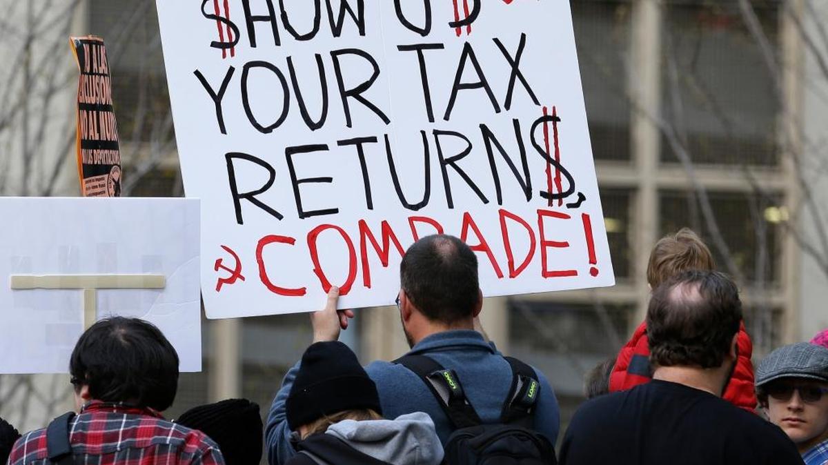 A protester in Seattle holds a sign during one of many rallies across the nation on Saturday calling on President Donald Trump to release his tax returns.