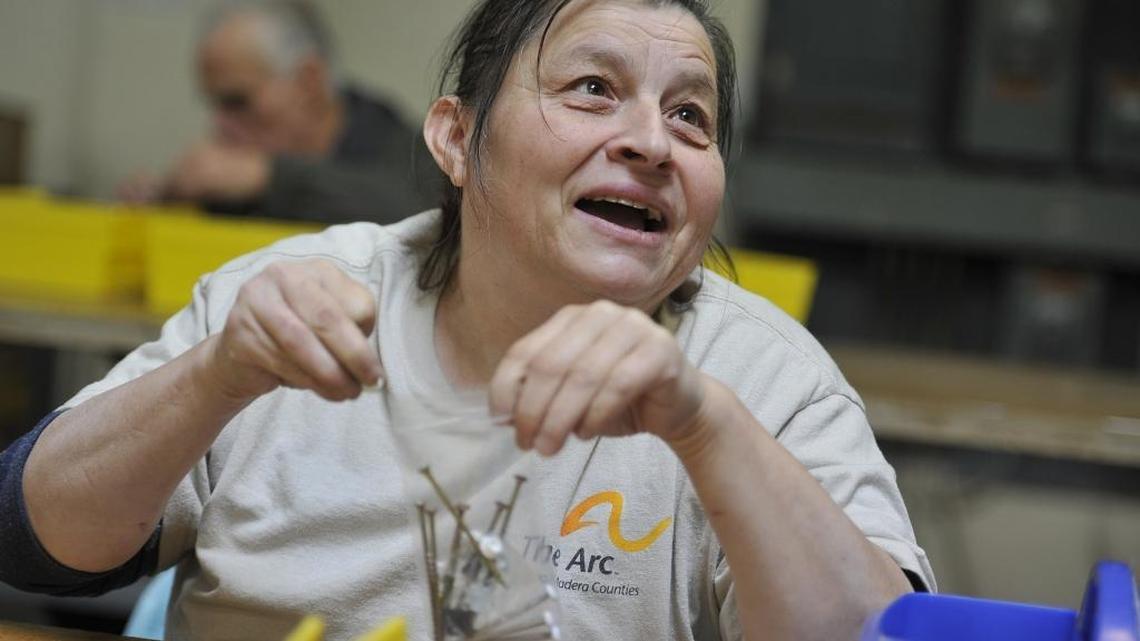 ARC client Lily Varela pauses to talk to a supervisor as she packages window installation kits for Anlin Window Systems at the ARC’s production center.