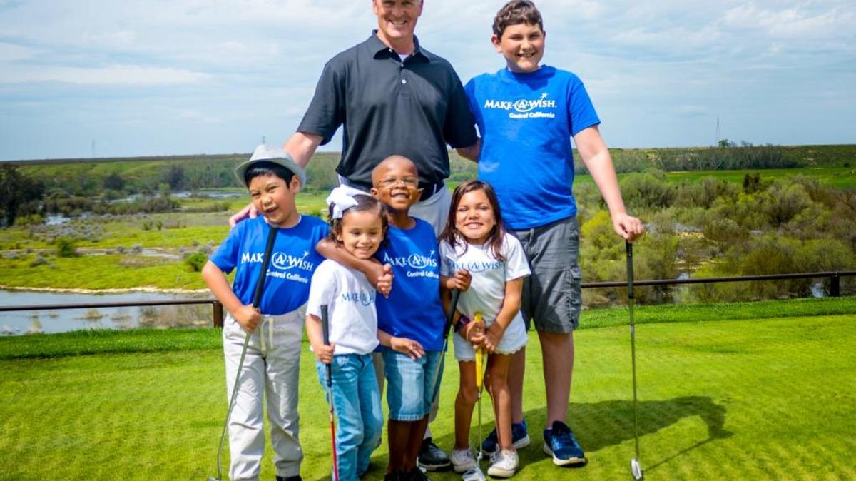 Tommy Masters, director of golf operations at San Joaquin Country Club, is joined by children from Make-A-Wish-Central California. The club hosted a charity tournament that raised $160,000 for the nonprofit, which makes wishes come true for kids with life-threatening diseases.