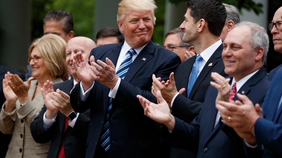 President Donald Trump celebrates with Speaker Paul Ryan in the Rose Garden of the White House after the House passed the American Health Care Act Thursday, May 4, 2017.