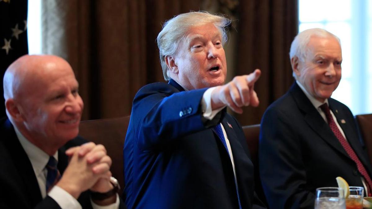 President Donald Trump, flanked by Rep. Kevin Brady, R-Texas, left, and Sen. Orrin Hatch, R-Utah, speaks during a meeting with lawmakers working on the tax bill on Wednesday.