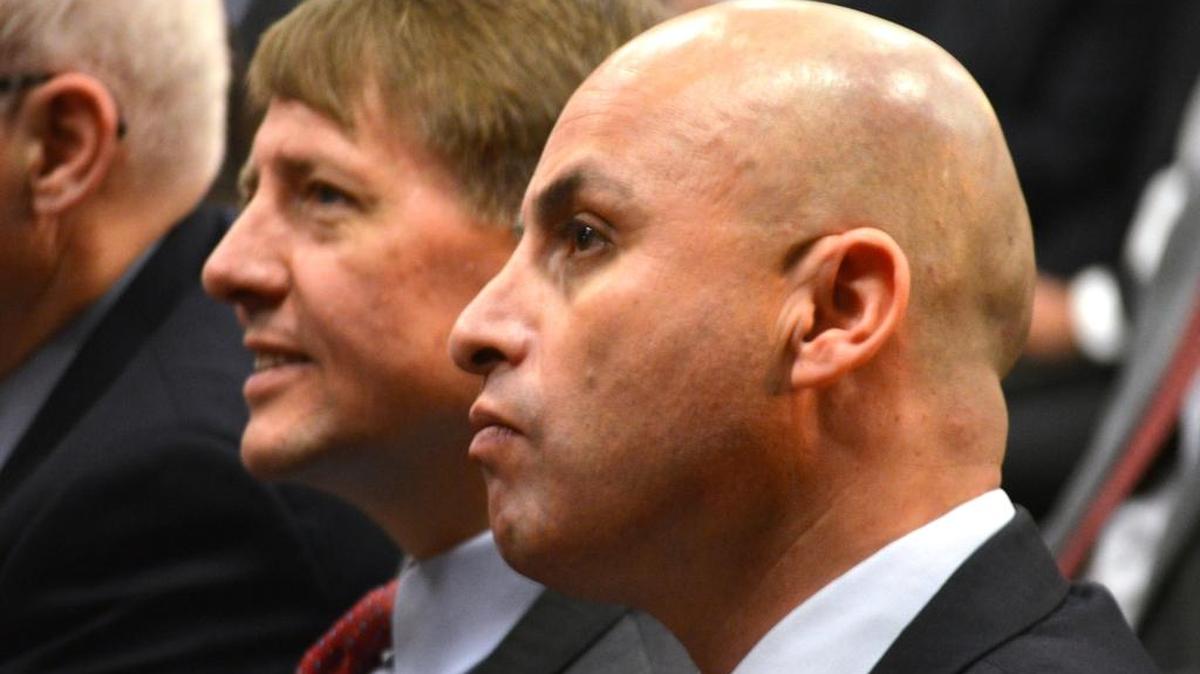 Consumer Financial Protection Bureau director Richard Cordray, left, and New Mexico Attorney General Hector Balderas sit at the Albuquerque Convention Center on Thursday before the bureau proposed to ban arbitration clauses that class-action lawsuits against financial firms over deceptive practices.