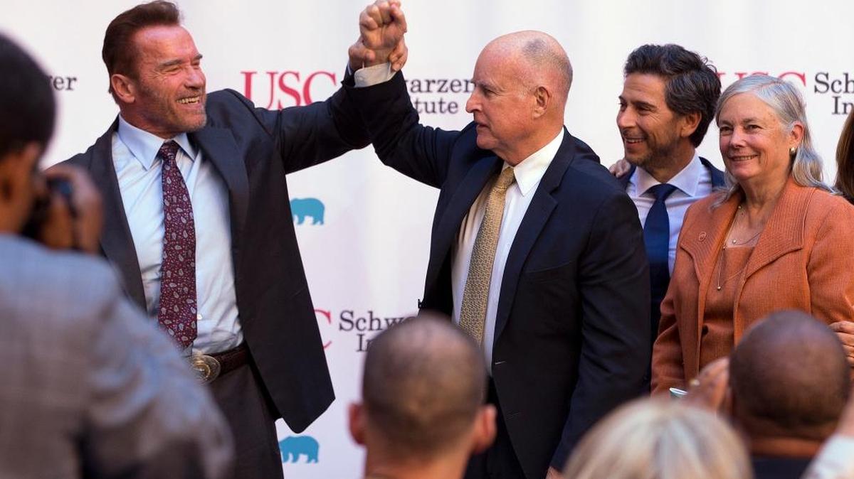 Former Gov. Arnold Schwarzenegger and Gov. Jerry Brown attend a celebration of the 10th anniversary of Schwarzenegger signing California’s landmark global warming bill, AB 32, Wednesday. Looking on are former Assembly Speaker Fabian Nuñez, D-Los Angeles, second from right, and Sen. Fran Pavley, D-Agoura Hills, the author of AB 32.