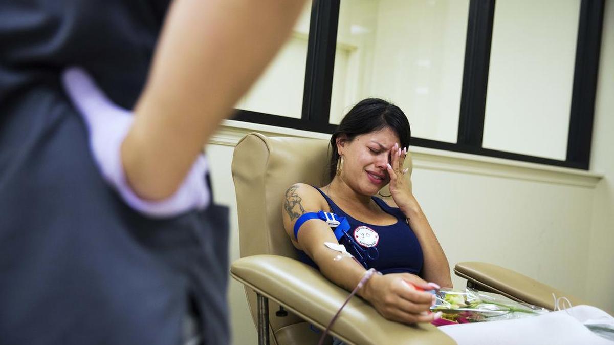 Tatiana Osorio cries while giving blood near the Orlando nightclub Pulse. Osorio lost three friends in the last weekend’s mass shooting at the gay club.