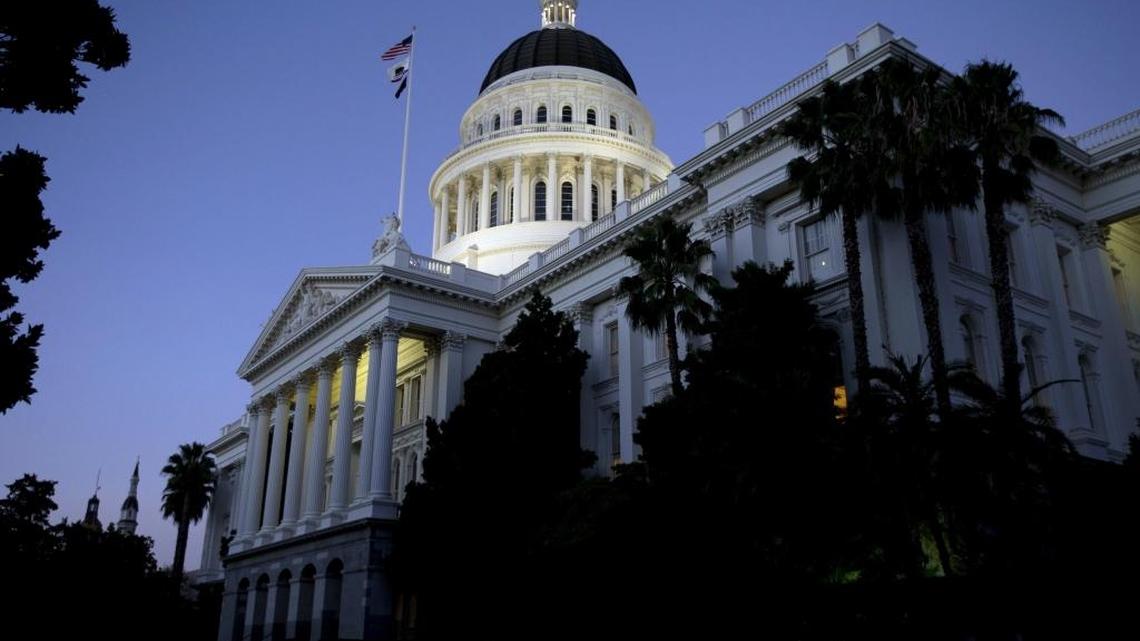 The state Capitol glows in the early evening in Sacramento.