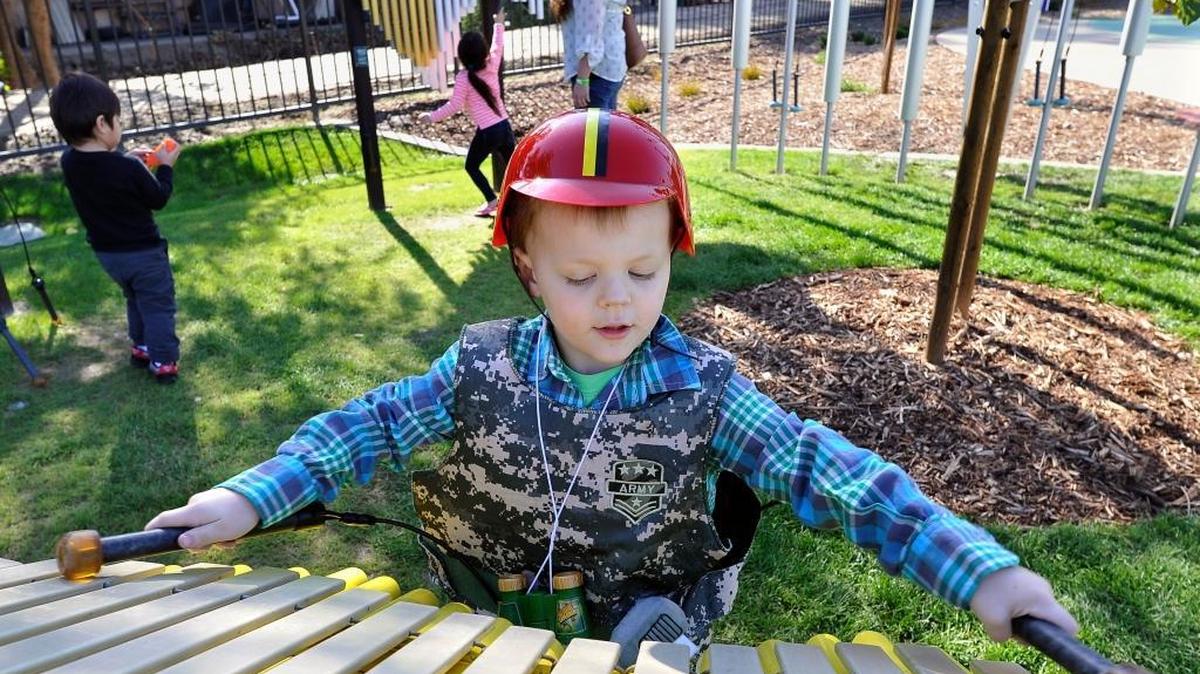 In the Harmony Garden at Imagine U Children's Museum, 4-year-old Chase Hammer discovers the sounds of a xylophone. Children also can play an outdoor marimba, tubular bells and drums.
