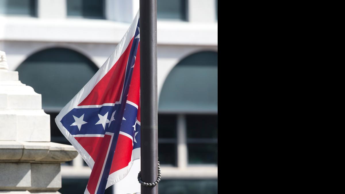 
An honor guard from the South Carolina Highway patrol removes the Confederate battle flag from the Capitol grounds in Columbia, S.C., Friday, ending its 54-year presence there. 

