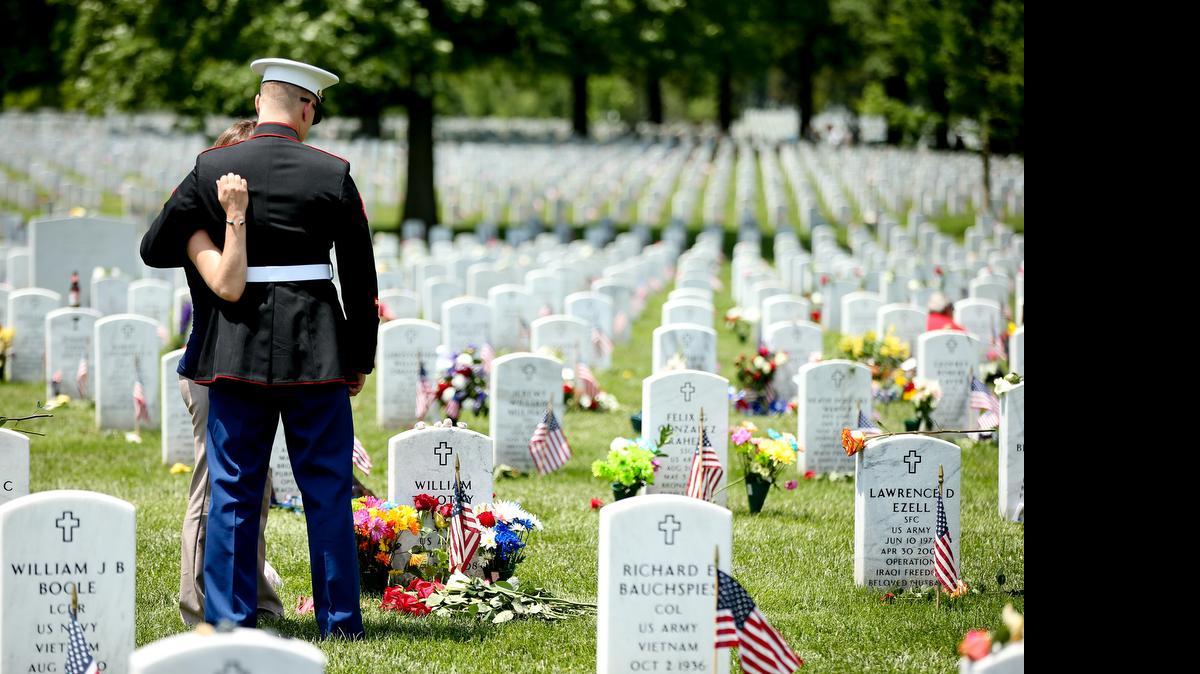 
Retired Marine Lance Cpl. Christopher Dix, of South Hill, Virginia, and girlfriend Lacey Foerter make a Memorial Day visit to the grave of Dix’s brother, Army Spc. William Timothy Dix, at Arlington National Cemetery. William Dix was killed in Iraq in 2008.
