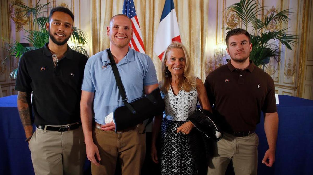 
Anthony Sadler, left, a senior at Sacramento State; U.S. National Guardsman Alek Skarlatos, right, of Roseburg, Oregon; and U.S. Airman Spencer Stone, second from left, pose for photographers with Jane D. Hartley, U.S. Ambassador to France, before a news conference Sunday at the ambassador’s residence in Paris. The men helped foil a potentially deadly attack when they subdued a suspected terrorist armed with an assault rifle and other weapons on a high-speed train bound for Paris. Monday the men received Legion of Honor medals. 
