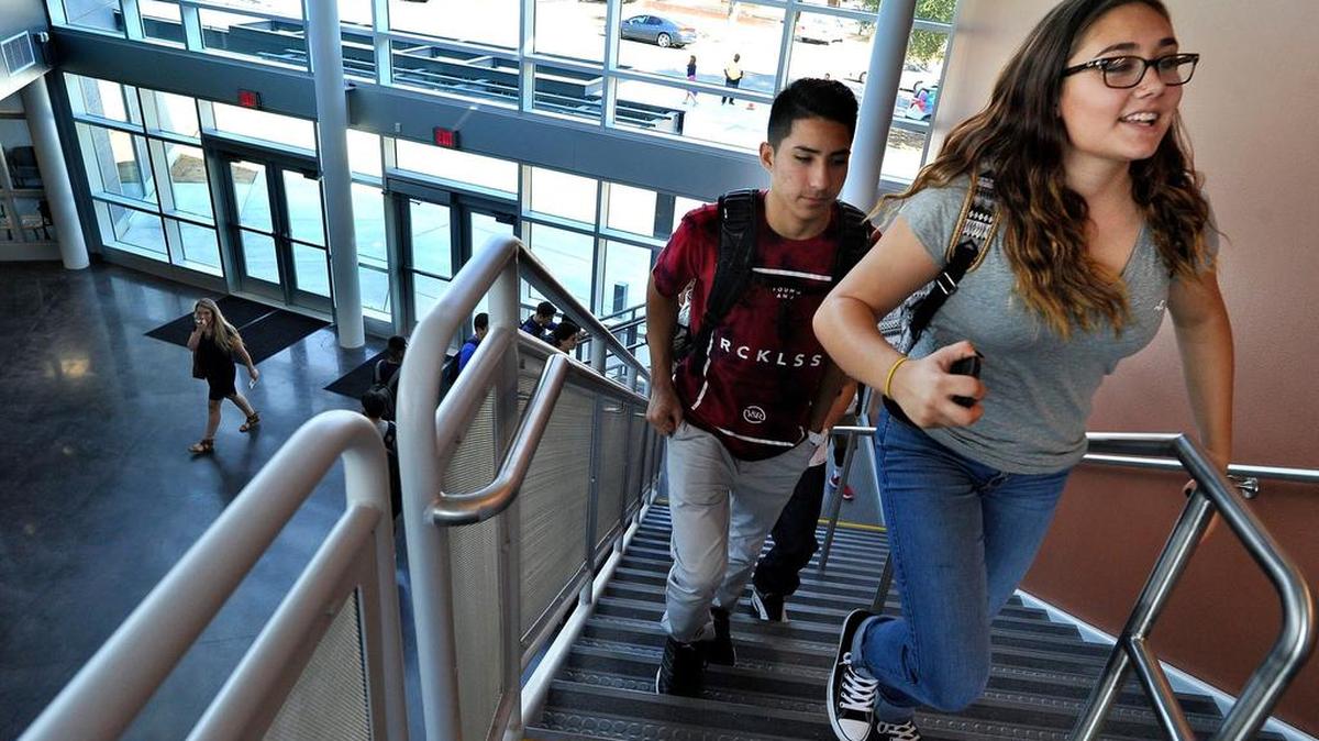 
Students Alison Morin, right, and Steven Caballero make their way to class on the first day at the new Phillip J. Patino School of Entrepreneurship.
