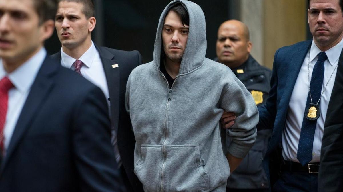 Martin Shkreli, the former hedge fund manager under fire for buying a pharmaceutical company and ratcheting up the price of a life-saving drug, is escorted by law enforcement agents in New York after being taken into custody following a securities probe. Shkreli resigned as the head of Turing Pharmaceuticals, one of the companies he runs, and another, KaloBios Pharmaceuticals, said Dec. 21, in a printed statement that it terminated Shkreli last week.