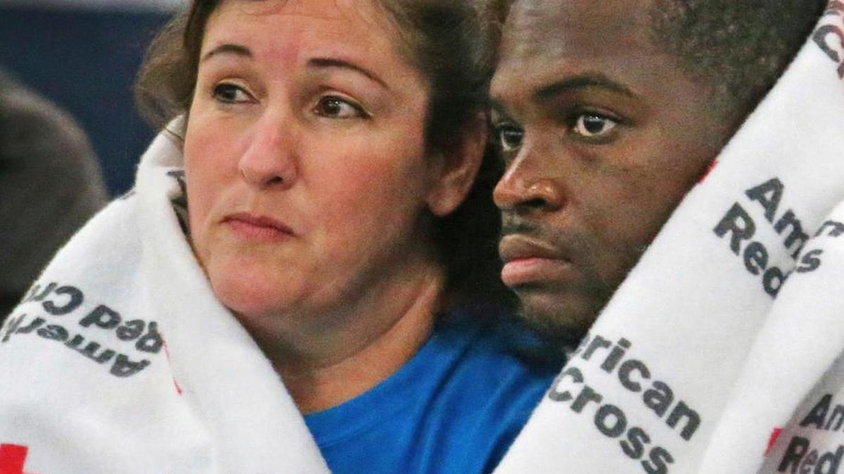 Displaced South Houston residents huddle underneath Red Cross blankets at the George Brown Convention Center in Houston on Monday in the wake of Tropical Storm Harvey. California organizations dispatched hundreds of volunteers and rescue personnel, and donated millions of dollars to the relief effort.