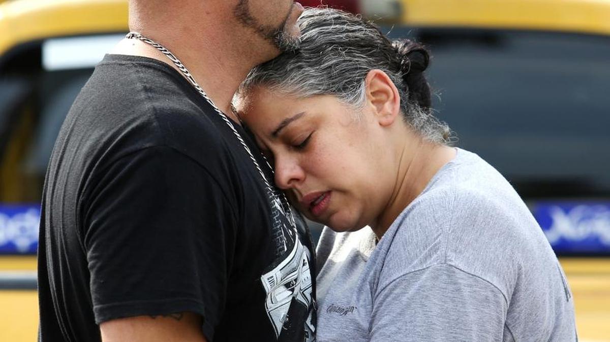 Ray Rivera, left, a DJ at Pulse Orlando nightclub, is consoled by a friend outside the Orlando Police Department after Sunday’s mass shooting.