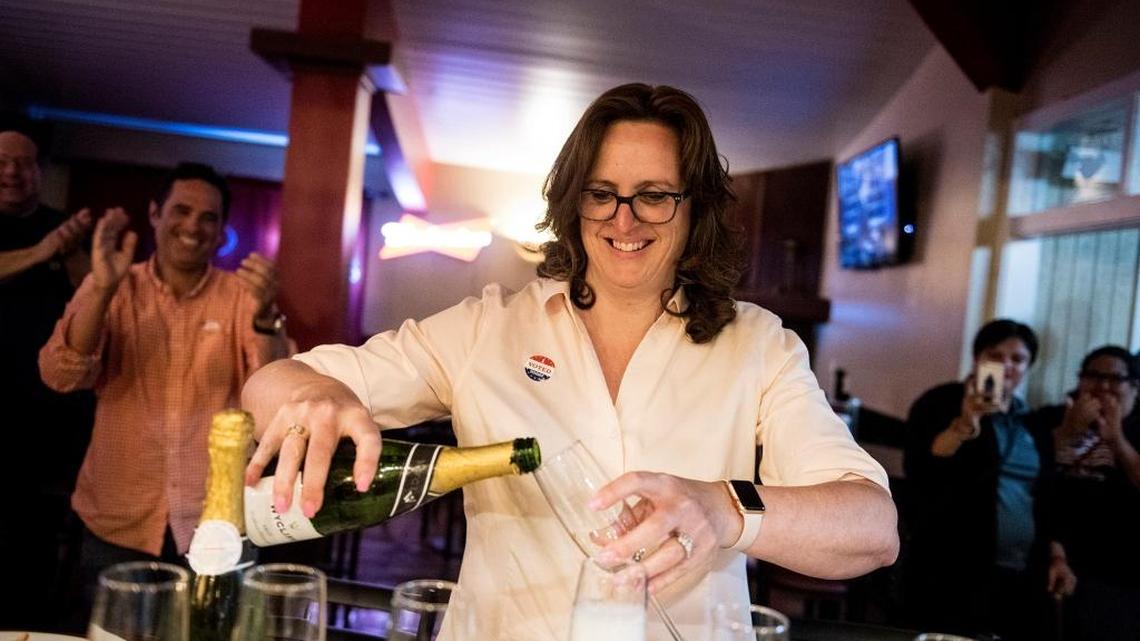 Merced County District Attorney candidate Kimberly Helms Lewis pours champagne as she celebrates her win over incumbent Larry D. Morse II, on Tuesday, June 5, 2018.