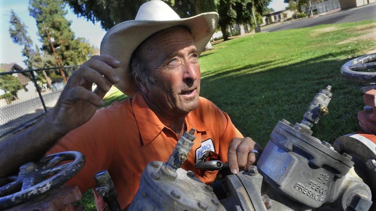 Wayne Fine, city of Fresno irrigation specialist, talks at a backflow device which he is tending to after damage to valves by vandals or homeless people camping in Roeding Park, who use pliers to turn, and thus, strip the brass as they attempt to gain access to water.