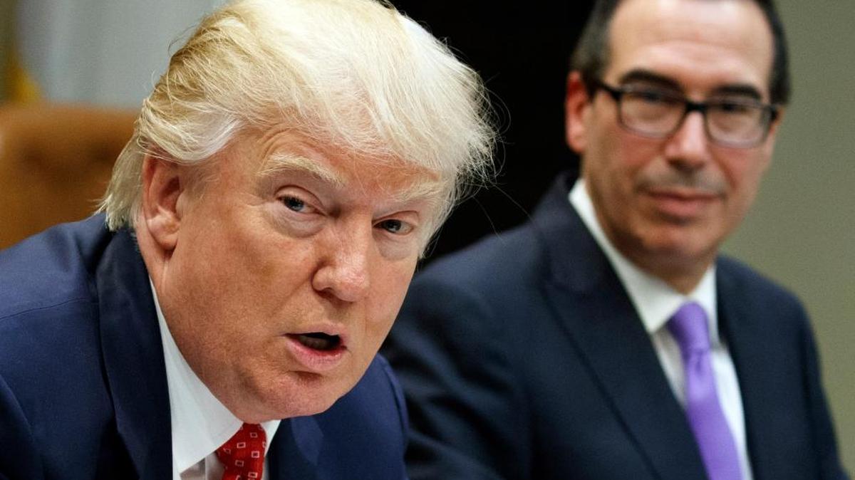 In this Feb. 22, 2017, photo, Treasury Secretary Steven Mnuchin, right, listens as President Donald Trump speaks about the federal budget at the White House. Trump wants to tackle tax reform, but the loss on health-care reform deprives Republicans of $1 trillion in tax cuts, and the GOP is divided on what steps to take.