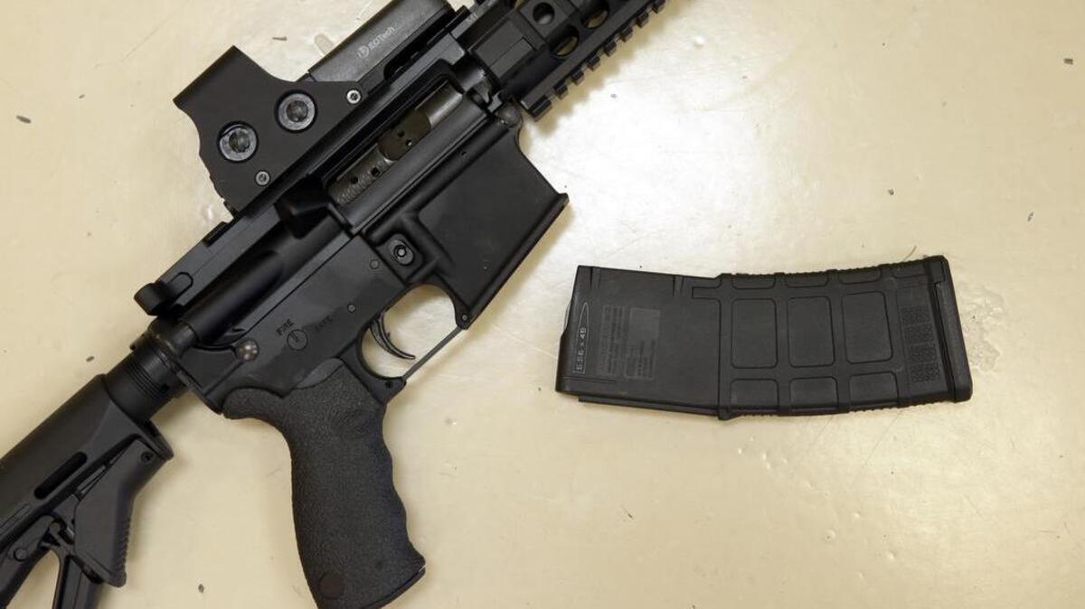 A custom-made semi-automatic hunting rifle with a high-capacity detachable magazine is displayed at TDS Guns in Rocklin. Though California has some of the nation’s toughest gun control laws, they are only as strong as enforcement in bordering states.