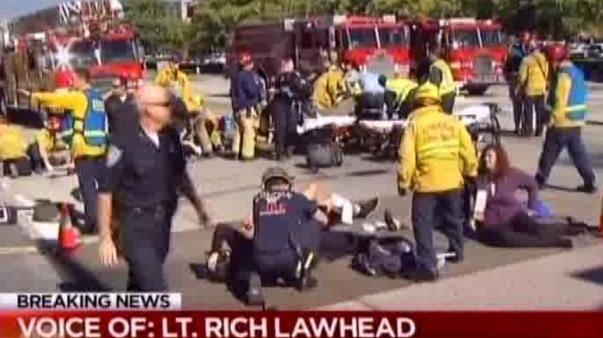 First responders attend to people outside a social services center in San Bernardino, where gunmen opened fire and killed at least 14 people Wednesday, Dec. 2, 2015.