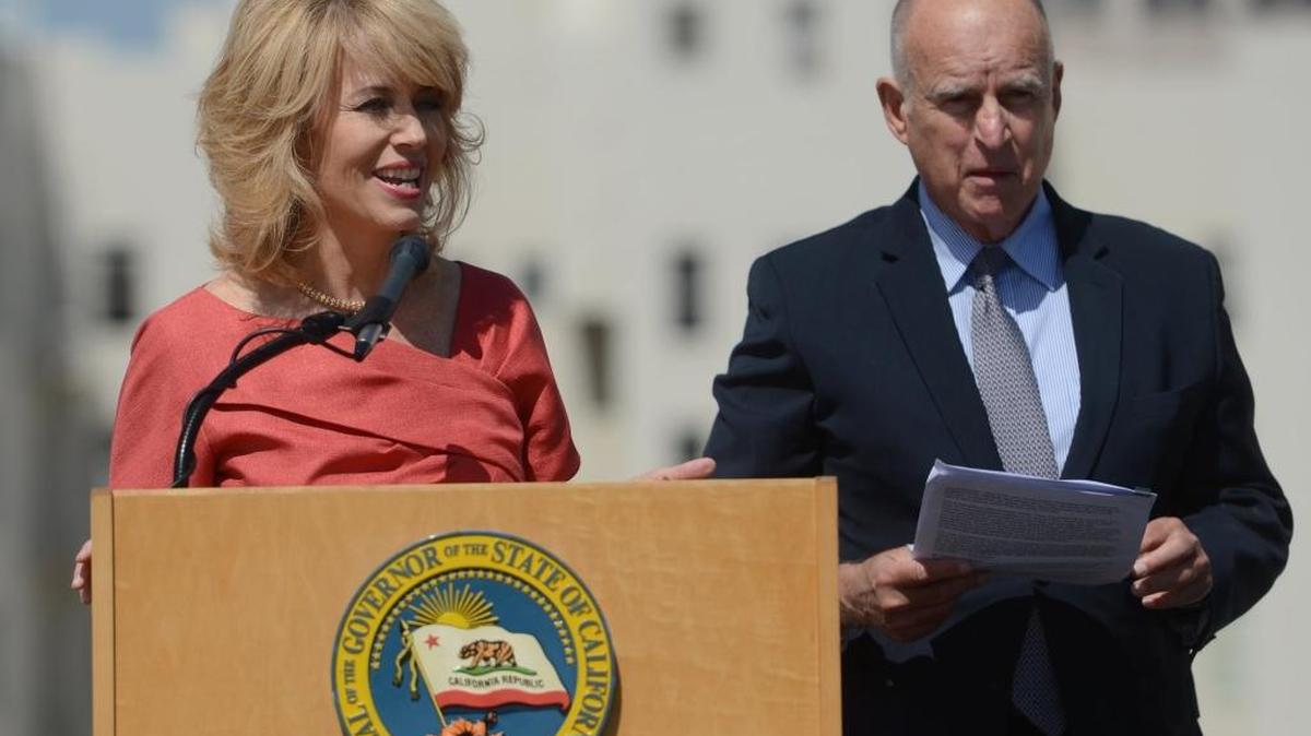 Fresno Mayor Ashley Swearengin, left, speaks before Gov. Jerry Brown signed a package of bills related to climate change Sept. 14, in downtown Fresno. AB 1613 and SB 859 direct $900 million in cap-and-trade funds to greenhouse gas-reducing programs that benefit disadvantaged communities, support clean transportation and protect natural ecosystems.