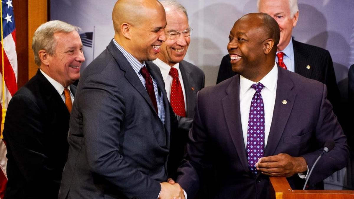 
Sen. Tim Scott, R-S.C., right, shakes hands with Sen. Cory Booker, D-N.J., at a Thursday, Oct. 1, 2015, news conference to discuss criminal justice reform. A long-awaited bipartisan proposal to cut mandatory prison sentences for nonviolent offenders and promote more early release from federal prisons was unveiled. From left: Senate minority whip Richard Durbin of Illinois; Booker; Senate Judiciary Committee Chairman Sen. Charles Grassley, R-Iowa; Scott; and Senate majority whip John Cornyn of Texas.
