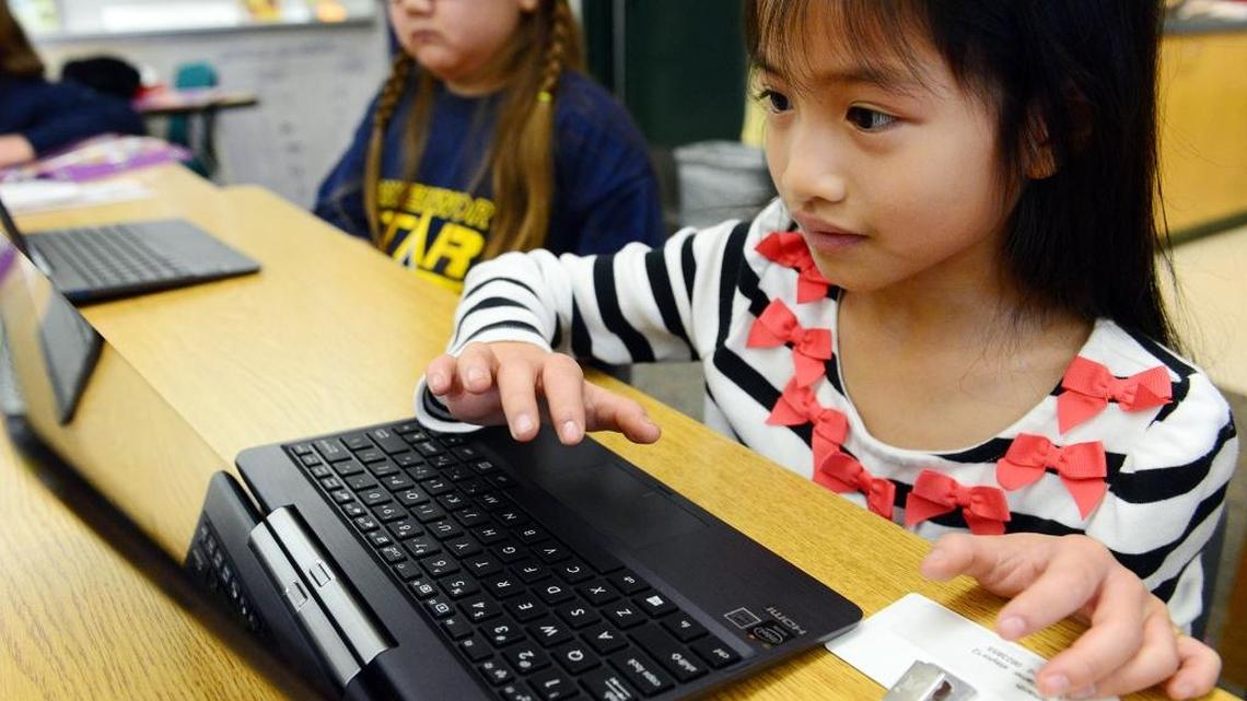 Samantha Taylor, right, and Carolina Lee get acquainted with tablets and keyboards in their classroom at Leavenworth Elementary School in preparation for Common Core state testing.