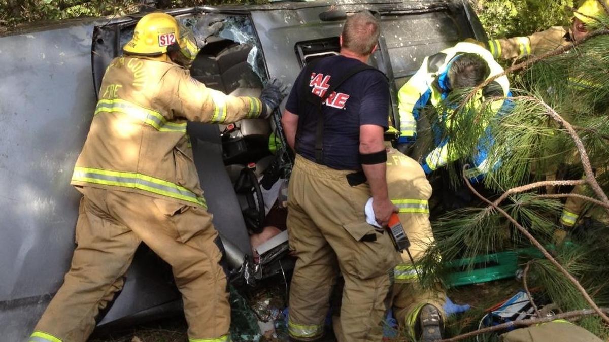 Cal Fire and Madera County firefighters, along with a Sierra Ambulance crew, work to free a Bass lake woman trapped in her car in March 2013 after it plunged 100 feet down an embankment. The Measure L public safety sales tax would provide the county with 25 additional firefighters and nine sheriff’s deputies.