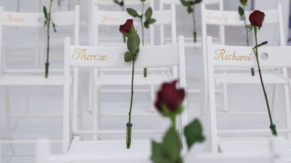 Roses on chairs with the names of those killed during a mass shooting at First Baptist Church in Sutherland Springs, Texas.
