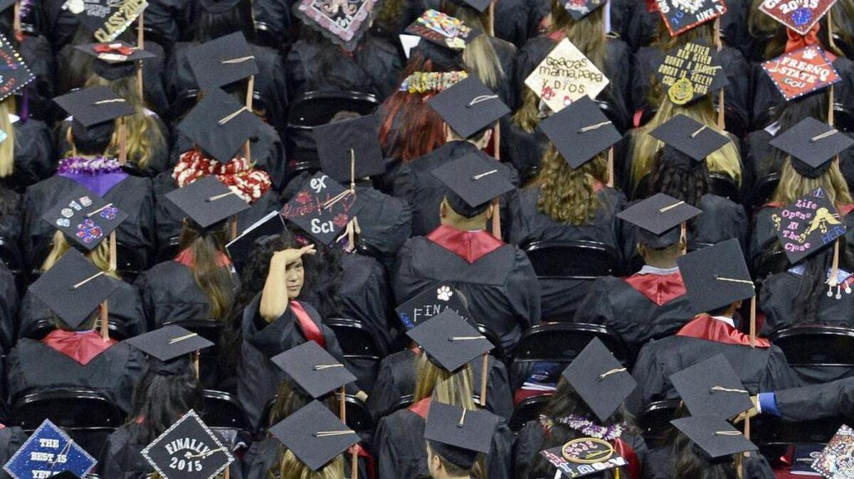 Fresno State graduating students sit in their seats in the Save Mart Center as the university’s 104th commencement gets underway in 2015.