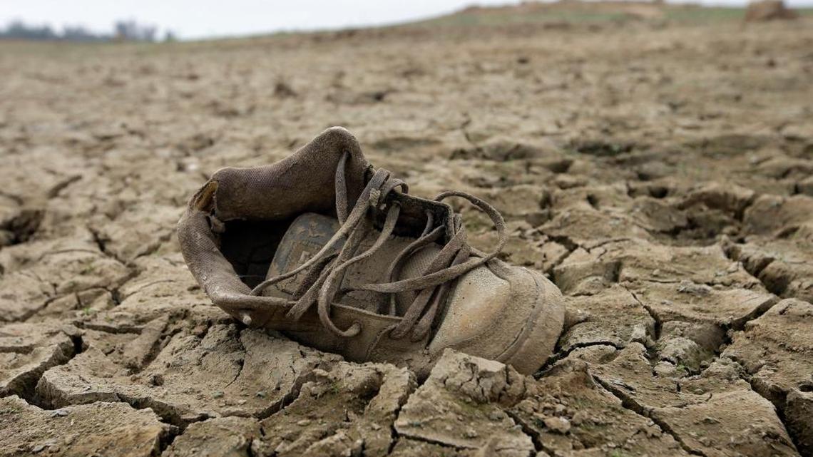 In this photo taken Oct. 27, 2015, a shoe sits on the dry lake bed at Folsom Lake east of Sacramento.