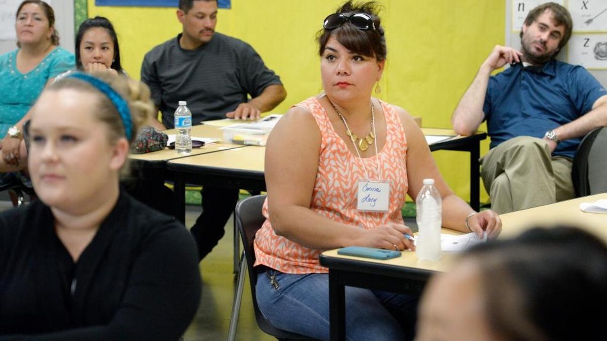First-year teacher Corina Lacy, center, sits among other new teachers as they receive training during a weekend program for Fresno Unified School District teachers at McLane High School last summer. State Senate Bill 807 would exempt teachers from paying California incomes taxes after five years as an instructor.