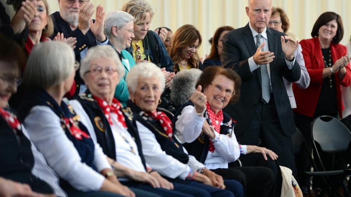
Gov. Jerry Brown stands to applaud female factory workers from World War II as he visits the Rosie the Riveter National Monument to sign the equal pay act into law on Tuesday, Oct. 6, in Richmond. 
