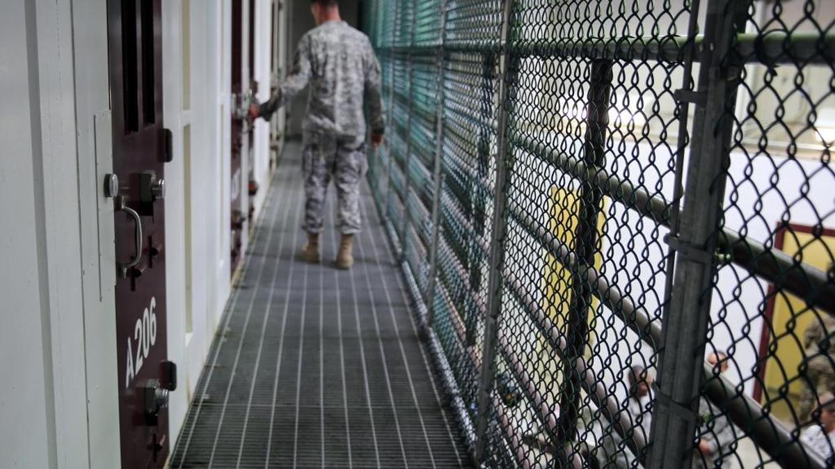 An Army captain walks outside unoccupied cells earlier this month inside Camp 6 at the detention center at Guantánamo Bay, Cuba.