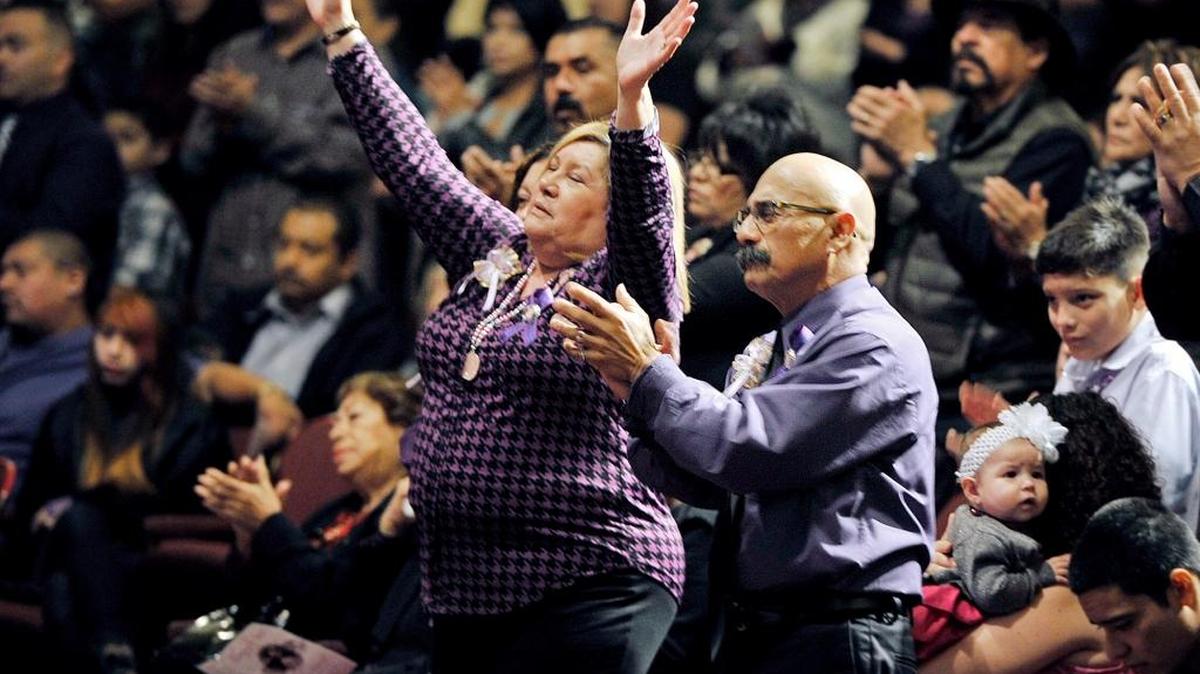 Janessa Ramirez’ grandparents Victoria Posas, left, and Frank Posas Sr., right, raise their hands and clap along in prayer during a memorial service for Janessa Danielle Ramirez at Cornerstone Church Saturday, Jan. 24, 2015 in Fresno. Janessa, 9, was killed by a stray bullet fired by a gang member Jan. 18 as she stood with her mother outside a laundromat.