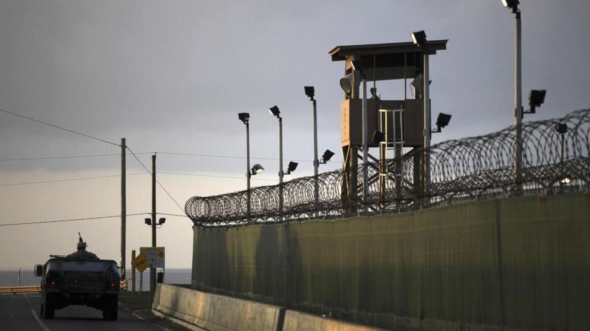 A guard looks out from a tower at the detention facility at Guantánamo Bay in Cuba in this March 2010 photo. The Senate on Tuesday overwhelmingly passed a defense bill barring any detainees from being transferred to the United States.