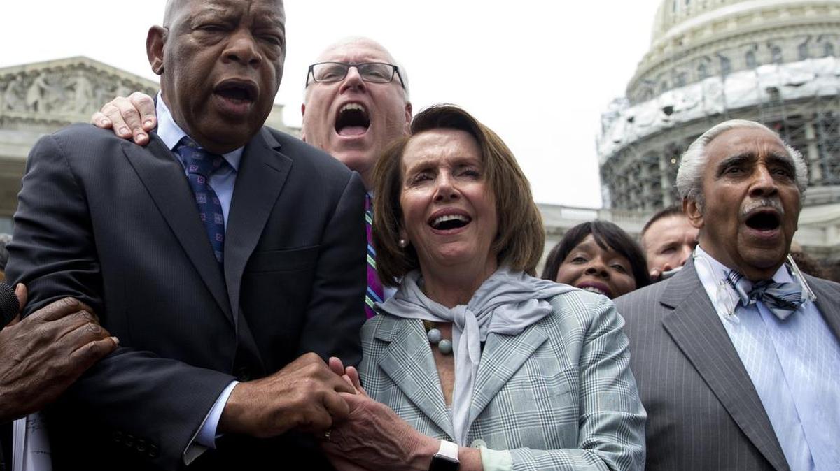 From left, Democratic Reps. John Lewis, Joseph Crowley, Nancy Pelosi and Charles Rangel sing “We Shall Overcome” on Capitol Hill in Washington.